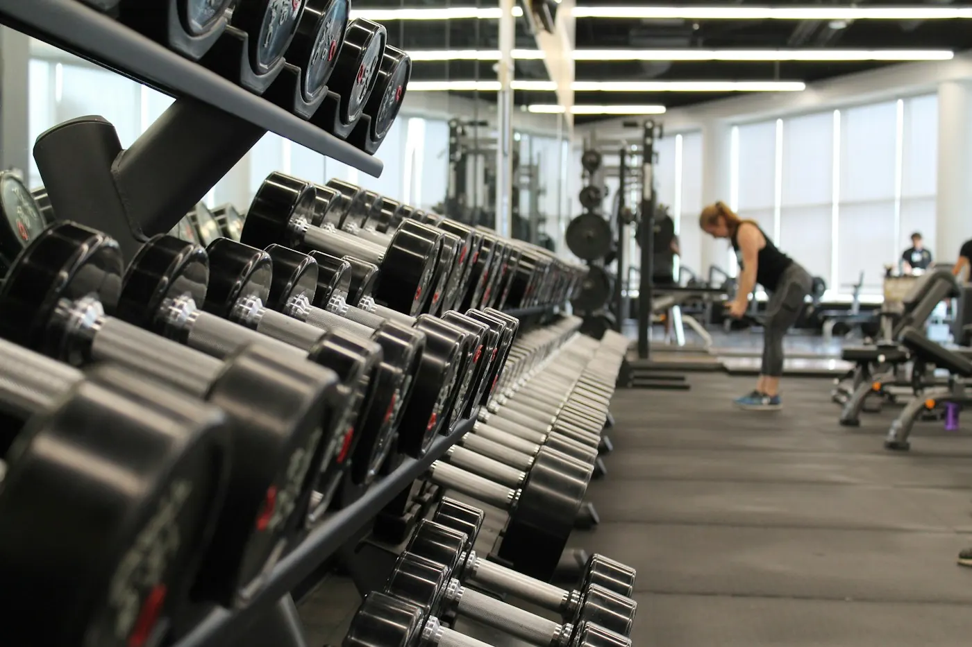 Rows of dumbbells in a bright gym